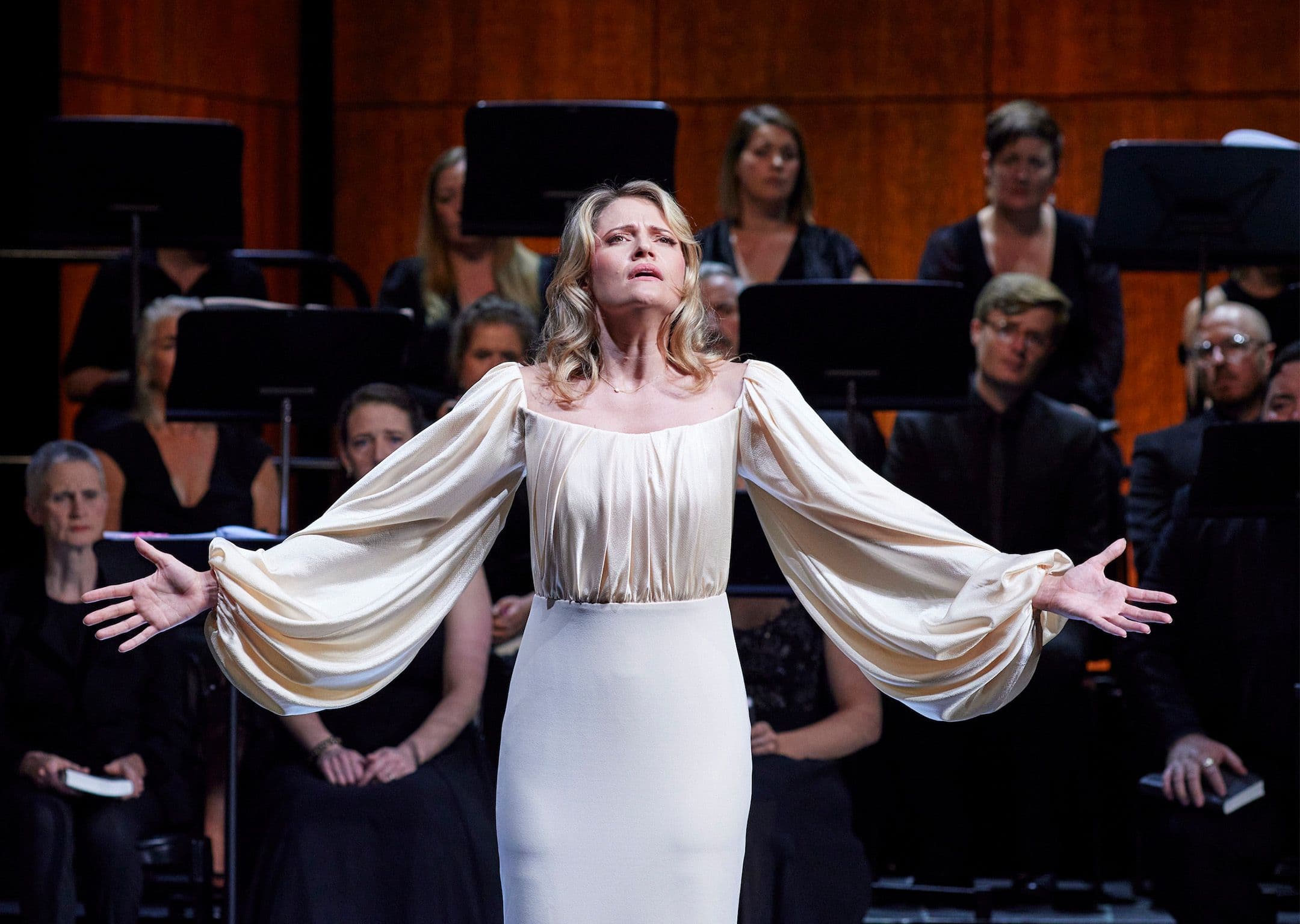 Soprano Samantha Clarke singing onstage in a white dress for Pinchgut Opera