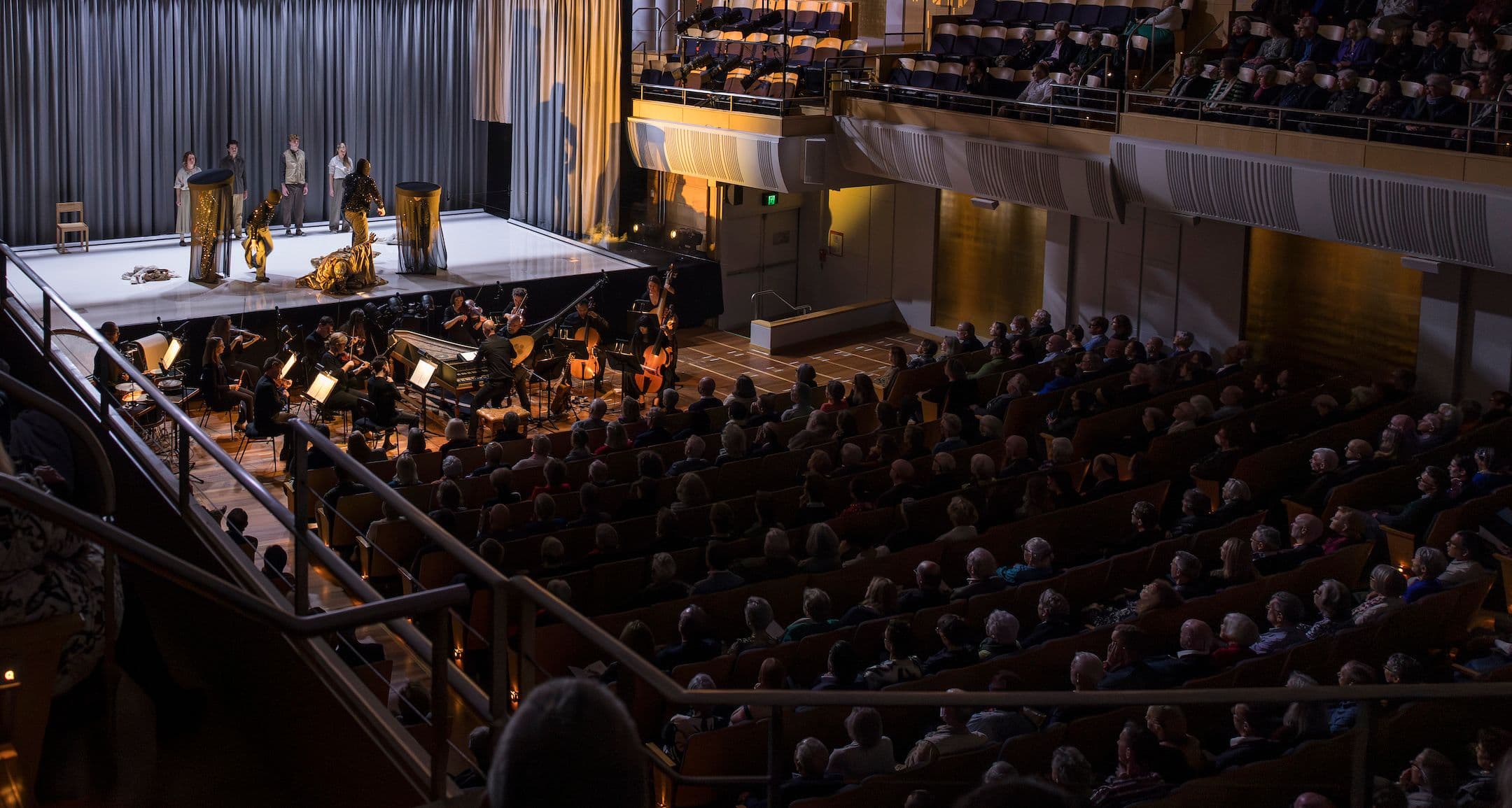 A audience fills the city recital hall, in their seats, watching a scene from Pinchgut Opera's Dido and Aeneas