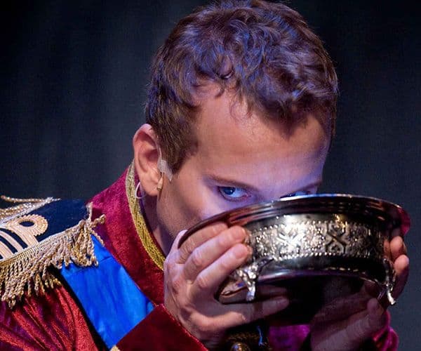 A singer onstage, drinking from a golden bowl in Pinchgut Opera performance of Juditha Triumphans at City Recital Hall